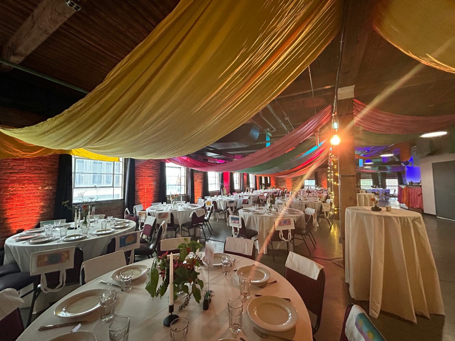 The Clybourn setup for a holiday party or gala with dining tables and full place settings